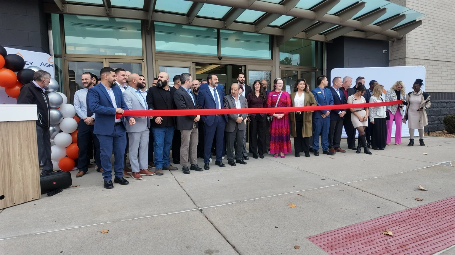 Ashley Furniture ribbon cutting outside the store entrance